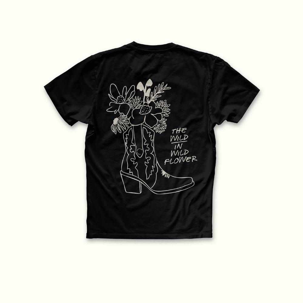 cowgirl boot with flowers inside and text the wild in wildflower to right hand side 